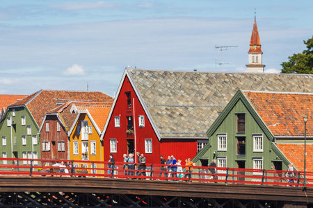TRONDHEIM, NORWAY - July 15, 2017. Tourists walking on Gamle Bybro - The Old Town Bridge, also known...
