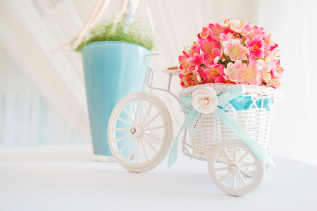 Decorative elements on wedding - white branch and decorative little bicycle with basket of flowers.の写真素材