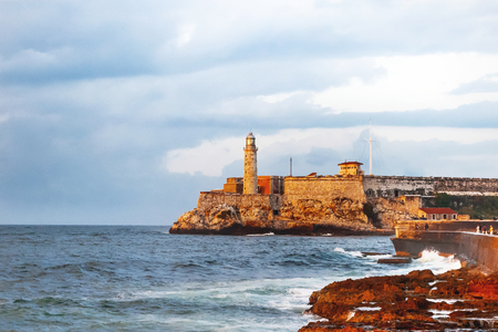Fortress and lighthouse of El Morro in the entrance of Havana bay, Cuba. Sunset after storm.の写真素材