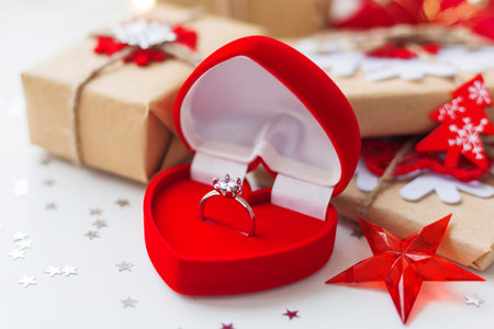 Christmas and New Year background with engagement ring and presents, decorations for Christmas tree....