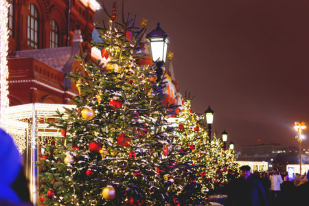 RUSSIA, MOSCOW - January 10, 2017. Streets in the historical center of Moscow. Fir trees with bright red and yellow balls and light bulbs.のeditorial素材