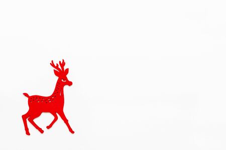 Wooden red running deer, Christmas and New Year decoration. Flat lay on white background, top view. Place for text.の写真素材