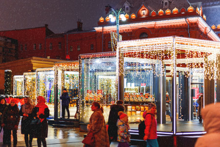 MOSCOW, RUSSIA - January 10, 2017. Streets in the historical center of Moscow decorated for New Year and Christmas celebration. Cafe windows with bright yellow stars and light bulbs. Russia.のeditorial素材