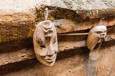 Pair of wooden theatre masks. Hand made overturn reversible objects with two sides with different emotions. Ubud, Bali island, Indonesia.の写真素材