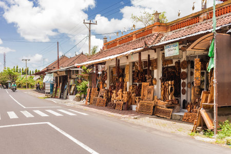 BALI, INDONESIA - January 30, 2013. Store with wooden carved statues. Pictures and sculptures for interior.のeditorial素材