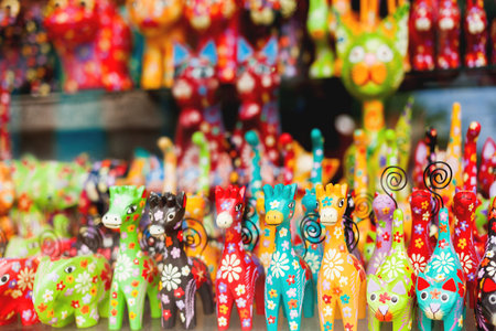 Sale of souvenirs - funny handmade wooden animals. Bright colorful children toys and decoration for interior. Ubud, Bali island, Indonesia.の写真素材