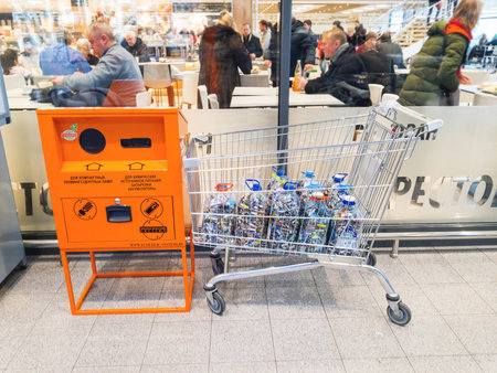 ODINTSOVO, RUSSIA - December 09, 2017. Separate waste collection - people bring batteries for recycling. Globus supermarket.のeditorial素材