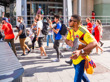 MOSCOW, RUSSIA - July 01, 2018. Tourists and local football fans walking on Nikolskaya street before...