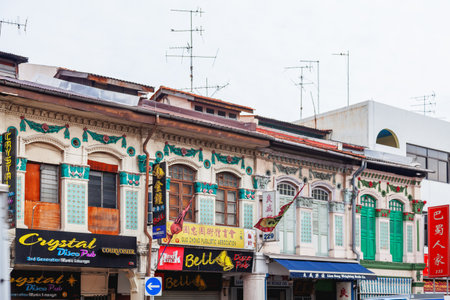 SINGAPORE, SINGAPORE - January 16, 2013. Colonial architecture of city. Buildings with many decorative elements, colorful jalousie and shop signs.のeditorial素材