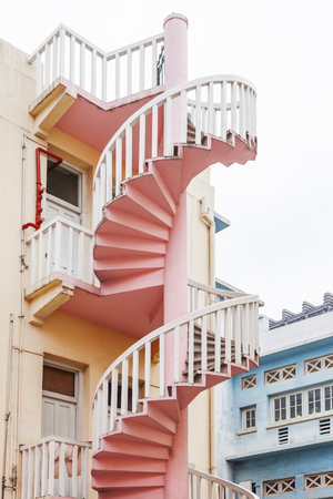Residential buildings (block of flats) with interesting architectural detail - colorful spiral outdoor stairs. Singapore.の写真素材