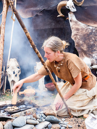 MOSCOW, RUSSIA - August 19, 2018. Woman dressed in animal skins as in ancient times. Annual festival Times and Epochs. Historical reconstruction of the Paleolithic, Mesolithic, Neolithic periods.のeditorial素材