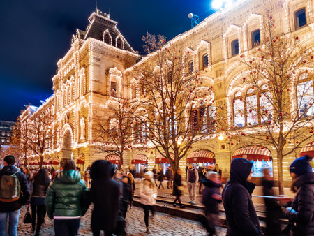 MOSCOW, RUSSIA - December 03, 2017. Streets of Moscow decorated for New Year and Christmas celebration. Crowd of people near GUM (Main Department Store) building with light bulbs.のeditorial素材