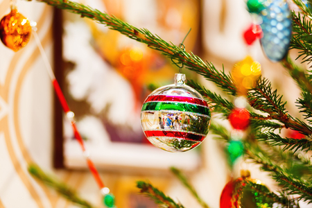 Fir tree decorated with shiny old fashioned balls and light bulbs for Christmas and New Year celebration.の写真素材