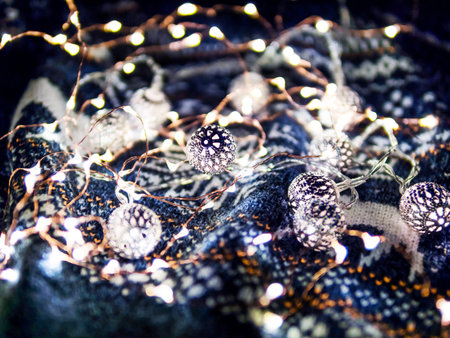 Christmas and New Year knitted pattern sweater with light bulbs. Cozy winter holiday decorations.