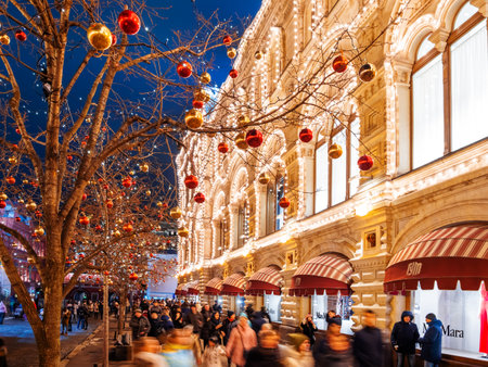 MOSCOW, RUSSIA - December 03, 2017. Streets of Moscow decorated for New Year and Christmas celebration. Crowd of people near GUM (Main Department Store) building with light bulbs.のeditorial素材