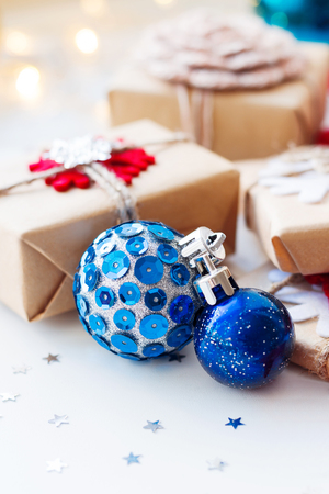 Christmas and New Year background with blue decorative balls, presents and decorations for Christmas tree. Holiday background with stars confetti and light bulbs. Place for text.の写真素材