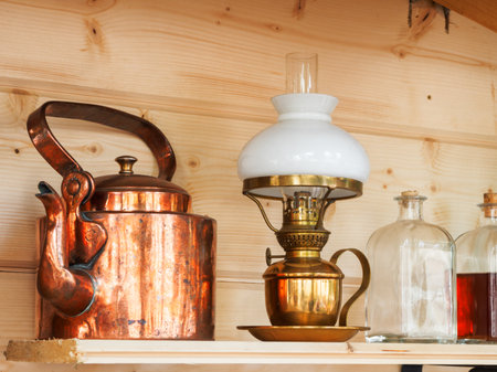 Vintage household items - copper teapot, table lamp, glass bottles with stoppers.のeditorial素材