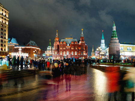 MOSCOW, RUSSIA - January 03, 2018. Locals and tourists walking near State Historical Museum. Night...
