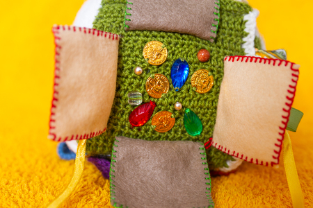 Colorful hand made toy for toddlers and babies. Busy cube. Soft  baby block made of fabric to develop skills and fine motor skills. Taggie Cube. Montessori busy toy.の写真素材