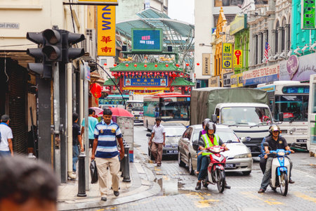KUALA LUMPUR, MALAYSIA - February 04, 2013. Local people and tourists on streets of Kuala Lumpur. Many signs and advertisements on the walls of buildings.のeditorial素材