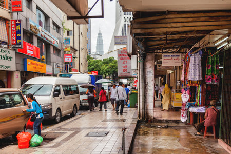 KUALA LUMPUR, MALAYSIA - February 04, 2013. Local people and tourists on streets of Kuala Lumpur. Many signs and advertisements on the walls of buildings.のeditorial素材