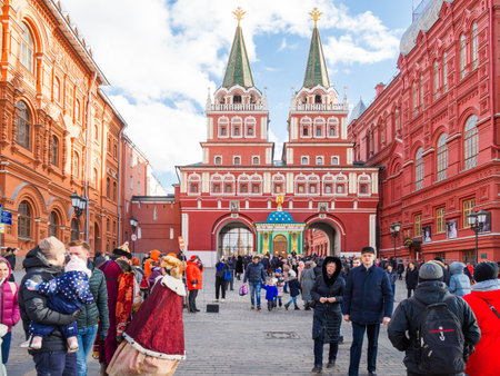 MOSCOW, RUSSIA - March 09, 2019. Tourists walking through Resurrection gate (Iverskaya Chapel),...