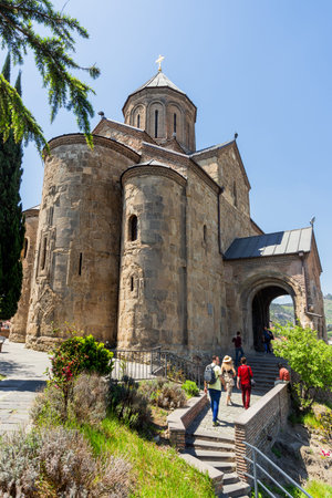 TBILISI, GEORGIA - May 1, 2017. Tourists near Metekhi Church of the Dormition of the virgin. Famous...