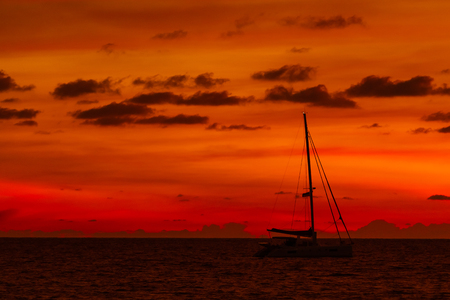 Silhouette of yacht on gorgeous sunset background. Nai Harn beach. Phuket island, Thailand, Indian ocean.の写真素材