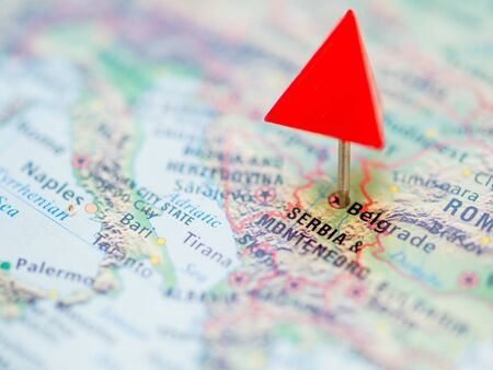 World map with focus on  Republic of Serbia and Montenegro with capital city Belgrade. Red triangle pin points on it.の写真素材