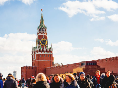 MOSCOW, RUSSIA - March 09, 2019. Local people and tourists walking near famous Spasskaya tower with...