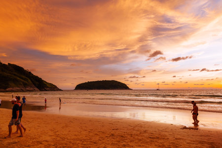 PHUKET, THAILAND - November 18, 2019.  Gorgeous sunset at Nai Harn beach. Tourists on Phuket island, Thailand, Indian ocean.のeditorial素材