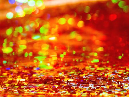 Bright red background. Shiny and sparkling holographic orange backdrop. の写真素材
