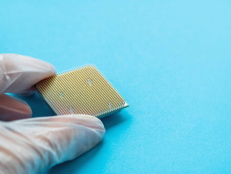 Hand in rubber glove with Central Computer Processor. CPU on blue background. Technological detail...