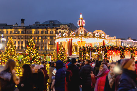 MOSCOW, RUSSIA - January 03, 2018. People walking in historic center of Moscow decorated to New Year and Christmas celebration. Decorative carousel with light bulbs on Manezhnaya square.のeditorial素材