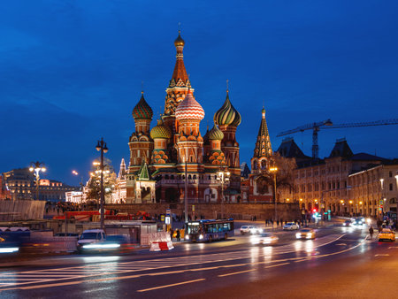 MOSCOW, RUSSIA - October 26, 2019. Cars and bus move pass famous landmark - St. Basil Cathedral on...