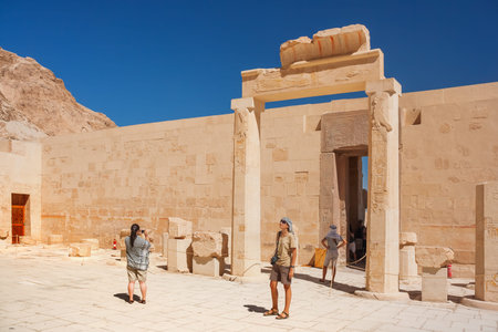 DEIR EL-BAHARI, Egypt - September 16, 2008. Group of tourists walk to famous mortuary temple of...