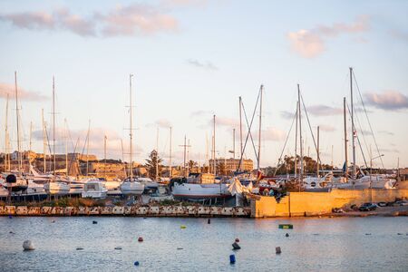 Dock with yachts on Marsamxett harbour. Many sailing ships lie alongside. Valletta, Malta.の写真素材