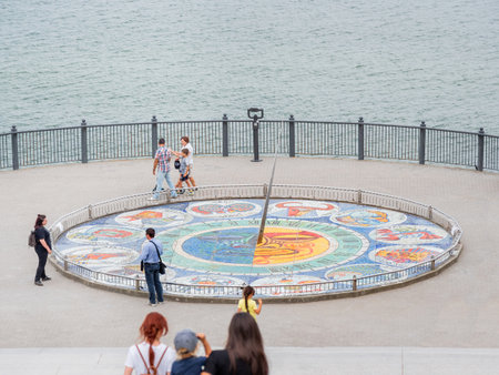 SVETLOGORSK, RUSSIA - July 21, 2019. Tourists near mosaic sun clocks Zodiak by Nikolay Frolov, art landmark of sea embankment of Svetlogorsk.のeditorial素材