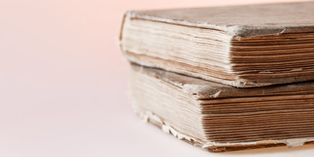 Banner with old books. Books with shabby covers and ragged pages on light pink background with copy...