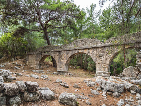 Ruins of aqueduct of ancient Phaselis city. Famous architectural landmark, Kemer district, Antalya province. Turkey.の写真素材