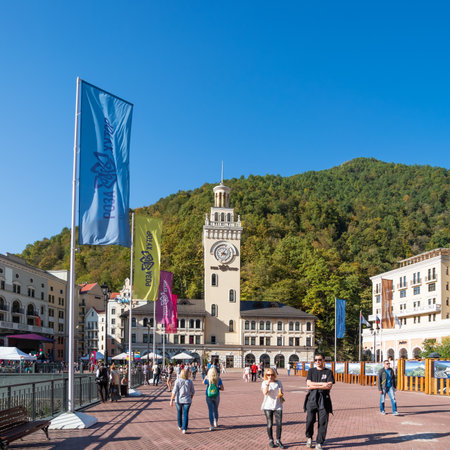 SOCHI, RUSSIA - October 13, 2018. Tourist walk near clock tower on Rosa square in Rosa Dolina. Famous Rosa Khutor Alpine Ski Resort near Sochi.のeditorial素材