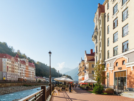 SOCHI, RUSSIA - October 13, 2018. Tourists walk on Mzymta river embankment in Rosa Dolina. Famous Rosa Khutor Alpine Ski Resort near Sochi.のeditorial素材