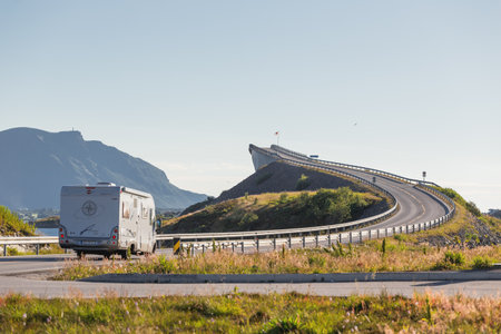 HUSTADVIKA, NORWAY - July 14, 2017. Camper goes on Atlantic Road near Storseisundet Bridge. Road trip by travel trailer in Norway.のeditorial素材
