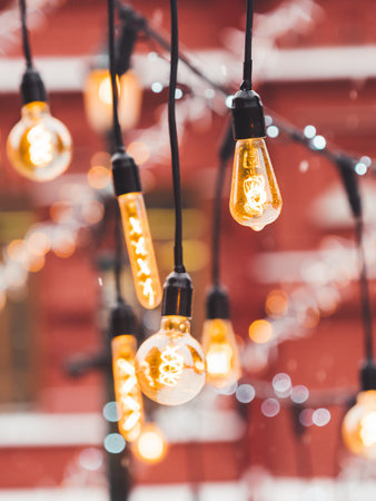 Vintage light bulbs with glow filament. Incandescent retro design. Outdoor decoration for New Year...