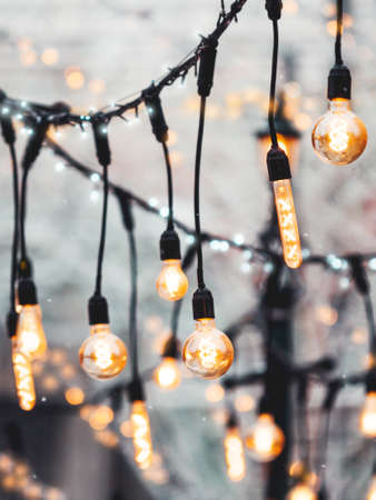 Vintage light bulbs with glow filament. Incandescent retro design. Outdoor decoration for New Year and Christmas celebration. Moscow, Russia.の写真素材