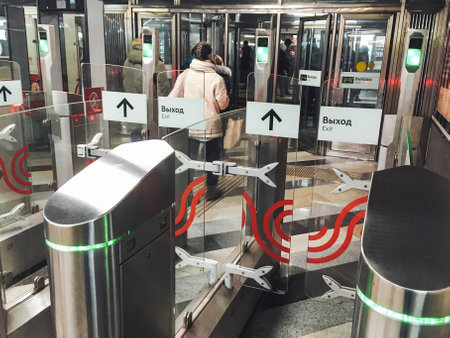 MOSCOW, RUSSIA - January 23, 2021. People exit through the turnstiles of the Moscow Metro. Passenger traffic in underground.のeditorial素材