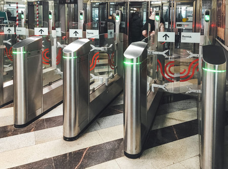 MOSCOW, RUSSIA - January 23, 2021. People exit through the turnstiles of the Moscow Metro. Passenger...