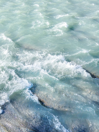 Blue water with foam waves. Deep sea. Peaceful ocean. Abstract natural background.