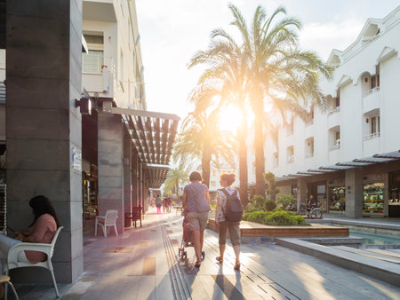 KEMER, TURKEY - May 13, 2018. Tourists walk down Munir Ozkul Liman street. Street with modern building, shops and flower beds.のeditorial素材