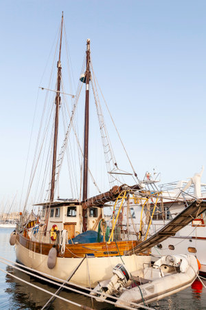 MSIDA, MALTA - February 17, 2010. Beautiful old fashioned sailing yacht moored at Msida Yacht Marina. Nautical vessel with sails, masts and inflatable boat.のeditorial素材